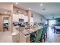 The spacious kitchen features an island with bar seating, granite countertops and is open to the living room at 680 Argyll Dr, Spring Hill, FL 34609