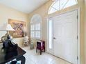 Bright foyer featuring tiled flooring, large windows, and neutral wall colors at 9336 Santa Monica Way, New Port Richey, FL 34655