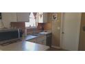 Functional kitchen features stainless steel sink, neutral countertops, and ample cabinet space at 10347 Caspian St, Spring Hill, FL 34608