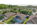 An aerial view captures a light-blue single-Gathering home with an attached two-car garage at 11041 Paradise Point Way, New Port Richey, FL 34654