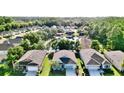 An aerial view showcases a residential neighborhood and a single-Gathering home at 11041 Paradise Point Way, New Port Richey, FL 34654