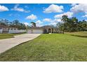 Beautiful single story home in a green, rural setting with a large front yard and a three car garage at 11336 Flower Ave, Weeki Wachee, FL 34613