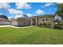 Well-manicured lawn and tasteful landscaping accent the side of this cream colored home at 11336 Flower Ave, Weeki Wachee, FL 34613