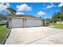 Spacious three-car garage with an extensive driveway offering ample parking space for Gathering and guests at 11336 Flower Ave, Weeki Wachee, FL 34613