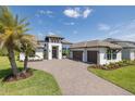 Beautiful home with a three-car garage, meticulous landscaping, and a grand entrance at 16557 Acoustic Loop, Land O Lakes, FL 34638
