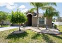 Well-maintained front yard showcasing lush landscaping, mature trees, and stone accents enhance the home's exterior at 18353 Briar Oaks Dr, Hudson, FL 34667