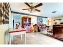 Spacious living room featuring tile flooring, ceiling fan and comfortable seating at 1919 Harpoon Dr, Holiday, FL 34690