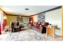 Bright living room featuring plush seating, decorative rug and ceiling fan at 1919 Harpoon Dr, Holiday, FL 34690