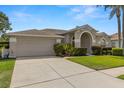 Well-maintained single-story home with manicured landscaping, ample driveway space, and a two-car garage at 22118 Yachtclub Ter, Land O Lakes, FL 34639