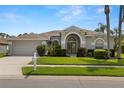 Inviting single-story home featuring a neatly landscaped front yard and a freshly painted mailbox at 22118 Yachtclub Ter, Land O Lakes, FL 34639