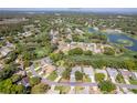 Aerial view of a property with a golf course and lake views in a residential neighborhood at 2327 Morning Glory Trl, Spring Hill, FL 34606