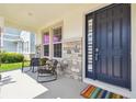 Cozy front porch featuring stone accents, seating, and a welcoming entrance at 3208 Living Coral Dr, Odessa, FL 33556