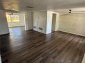 Open-concept living room boasting wood-look flooring, multiple windows, and a neutral color palette at 3617 Rockaway Dr, Holiday, FL 34691