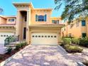 Stunning townhouse with an attached two-car garage and well manicured landscaping at 3655 Square West Ln # 9, Sarasota, FL 34238