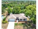 An aerial view of the home with lush trees at 5378 Mosquero Rd, Spring Hill, FL 34606
