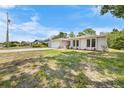Single-story home with a well manicured lawn and lots of trees at 5378 Mosquero Rd, Spring Hill, FL 34606