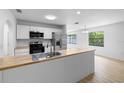 Bright, open kitchen with stainless steel appliances and modern butcher block countertops at 5378 Mosquero Rd, Spring Hill, FL 34606