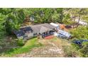 Aerial view of a cozy home featuring a front porch, boat and ample parking at 6203 Sumter Dr, Brooksville, FL 34602