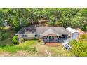 Aerial shot showcasing a charming single-story home with inviting front porch and spacious yard at 6203 Sumter Dr, Brooksville, FL 34602