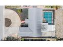 Aerial view showcasing the property layout with a pool and extensive driveway at 6611 Ridge Crest Dr, Port Richey, FL 34668