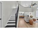 Bright and airy living room with high ceilings, modern staircase, and open floor plan at 7129 Hideaway Trl, New Port Richey, FL 34655