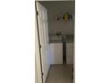 Functional laundry room equipped with a washer, dryer, and storage shelf for cleaning supplies at 7144 Gulf Breeze Cir, Hudson, FL 34667