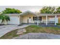 Charming single-story home with a well-manicured lawn and a welcoming front porch at 7235 Astor Dr, New Port Richey, FL 34652