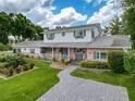 Charming two-story home with brick accents, lovely landscaping, and inviting front porch at 75 N Canal Dr, Palm Harbor, FL 34684