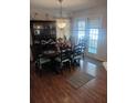 Traditional dining room featuring a dark wood table, chairs, and hutch with natural light at 8008 La Serena Dr, Tampa, FL 33614