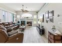Cozy living room with a fireplace, ample seating, and plenty of natural light at 8137 Morning View Dr, Hudson, FL 34667