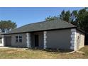 View of the right of home with well-maintained landscaping and modern exterior, showcasing the home's curb appeal at 8413 Monarch Dr, Port Richey, FL 34668