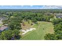 Aerial view of a lush golf course community with mature trees at 888 Royal Birkdale Dr, Tarpon Springs, FL 34688