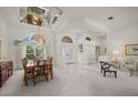 Elegant dining room featuring a large window, chandelier, and neutral-toned decor at 888 Royal Birkdale Dr, Tarpon Springs, FL 34688