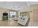 Living area with hardwood floors, a ceiling fan, an open floorplan, and a display shelving unit at 9088 Gallup Cir, Spring Hill, FL 34608