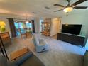 Bright living room features a ceiling fan, modern furniture, and access to the patio at 9186 Patio Ct, Spring Hill, FL 34608