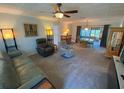 Cozy living room with comfortable seating, soft carpet and natural lighting at 9186 Patio Ct, Spring Hill, FL 34608