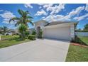 Charming single-story home features a well-maintained lawn, a concrete driveway and attached two car garage at 10106 Tolman Dr, Hudson, FL 34667