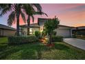Charming home exterior with landscaped yard and a two car garage at 10106 Tolman Dr, Hudson, FL 34667