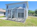 Backyard view featuring a screened-in patio, perfect for enjoying the outdoors bug-free at 10238 Perthshire Cir, Land O Lakes, FL 34638