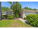 Charming single-Gathering home featuring a well-manicured lawn, lush landscaping, and a two-car garage at 1119 Dustan Pl, Trinity, FL 34655