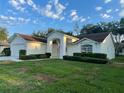 Charming single-story home with a well-maintained lawn, double door entry, and attached two-car garage at 11213 Brooklawn Dr, Hudson, FL 34667