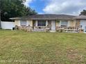 Charming single Gathering house featuring a stone facade, lovely landscaping, and a cozy front porch at 1127 Lodge Cir, Spring Hill, FL 34606