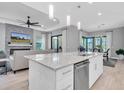 Open-concept kitchen features a granite island, stainless steel appliances, and an adjacent living area at 11325 Juglans Dr, Odessa, FL 33556