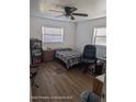 This bedroom features a ceiling fan and wood-look flooring at 12116 Lamont Dr, Spring Hill, FL 34608