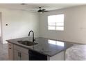 Bright kitchen with large island, granite countertops, undermount sink, and modern fixtures at 12630 Aston Dr, Hudson, FL 34669