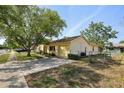 View of the property showing a driveway, attached garage, and partial fencing at 12906 Sandburst Ln, Hudson, FL 34667