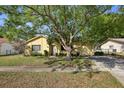 Inviting single-story home featuring a lush front yard and mature tree offering plenty of shade at 12906 Sandburst Ln, Hudson, FL 34667