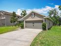 A well-maintained home featuring a spacious driveway leading to an attached two-car garage at 13111 Precept Way, Hudson, FL 34669