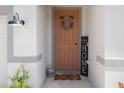Inviting front entry featuring a decorative wreath, welcome mat, and a 'HOME' sign at 13205 Arkendale St, Spring Hill, FL 34609