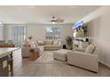 Cozy living room with comfortable seating, a ceiling fan, and a mounted TV at 13205 Arkendale St, Spring Hill, FL 34609